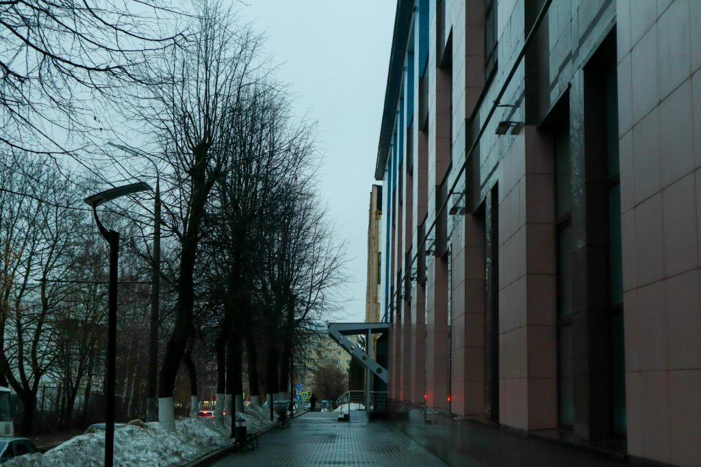 a street lined with tall buildings next to trees